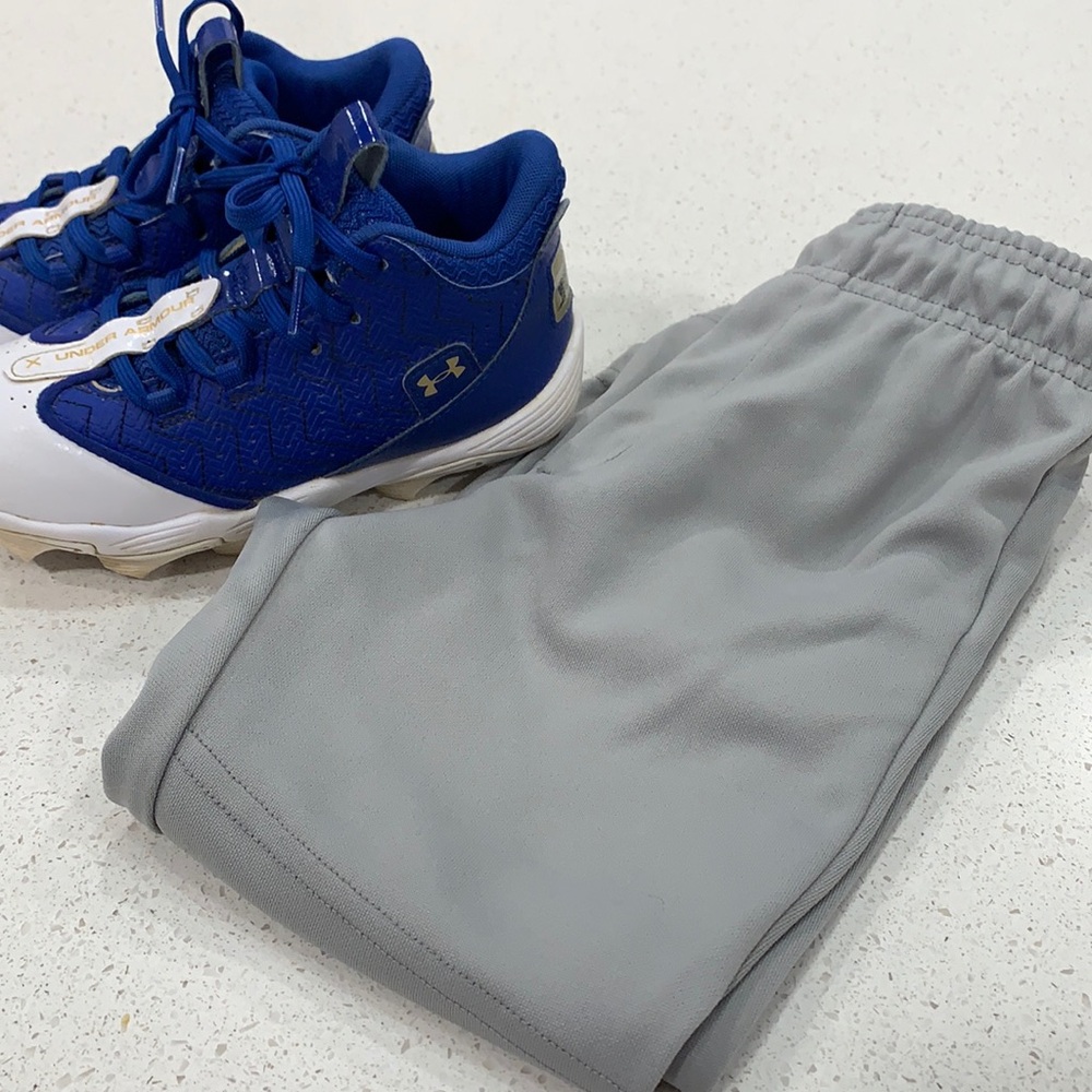 Boys Under Armour cleats size 1.5 and youth small baseball pants
